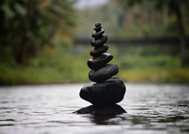 Black stones in a stream - Stacked largest to smallest
