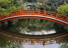 Red wooden foot bridge over water